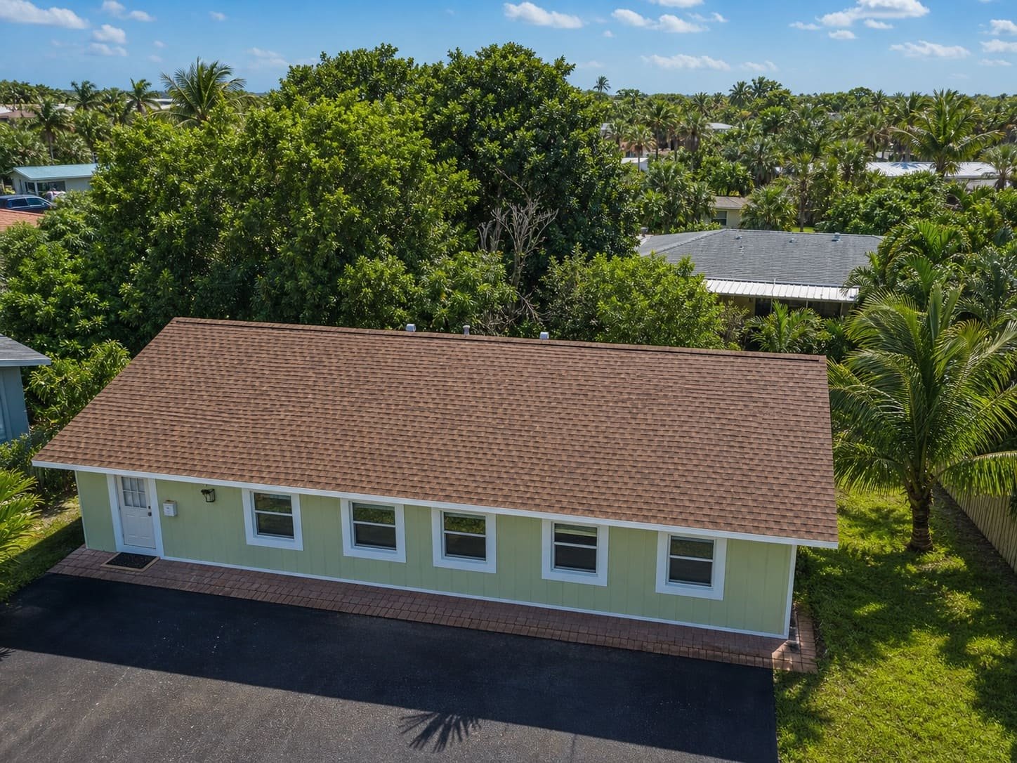 The same home fully restored under a new shingle roof