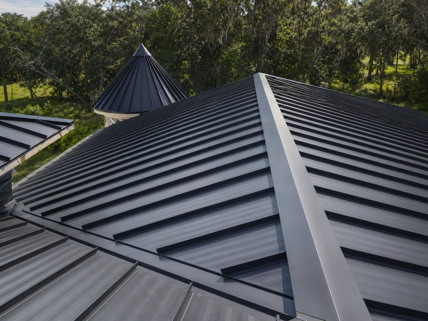 Close view of a standing-seam metal roof ridge and hip trim