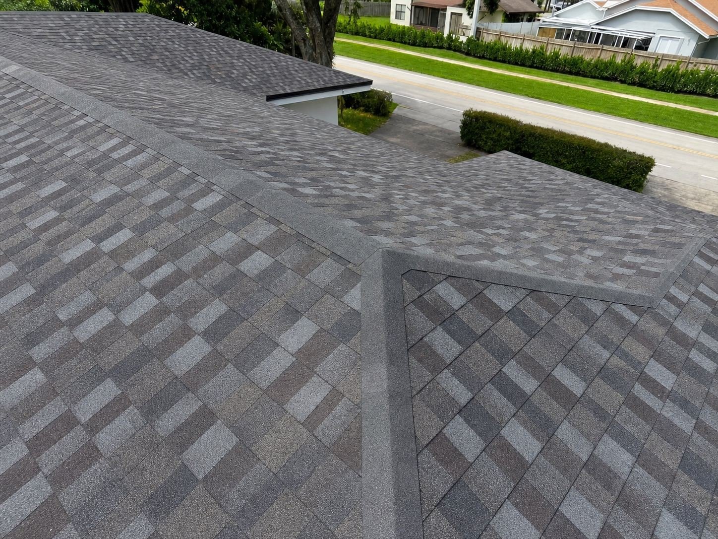 Close view of shingle valleys and ridge capping on a finished roof