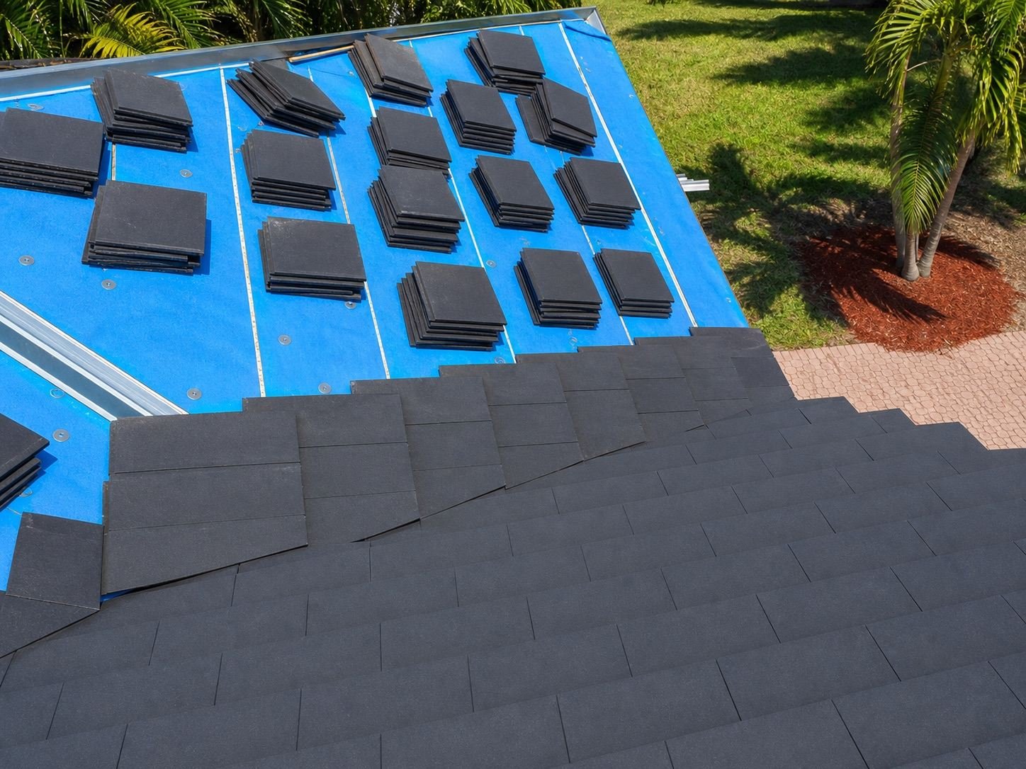Roof tiles being laid in courses across a roof slope during installation