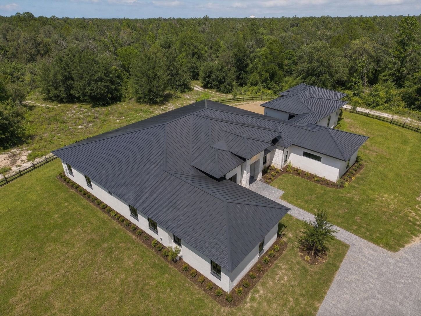 Aerial view of a completed standing-seam metal roof showing full panel runs